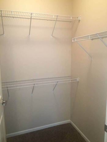 A walk in closet in a bedroom